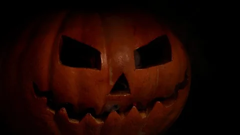 Carved terrible pumpkin, in hellfire. A crazy face from the eyes burns fire. Stock Footage 116891410