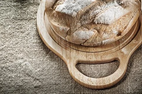 Carving board Bread on burlap background Stock Photos
