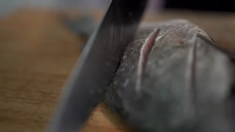 Carving the fish for marination Stock Footage 131046433