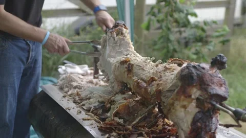 Carving hog roast at event Stock Footage 247331265