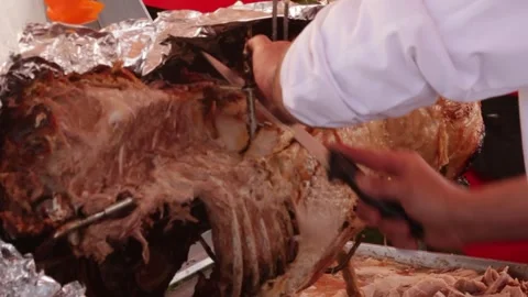 Carving meat outside at bbq Stock Footage 274075919