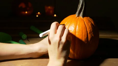 Carving out pumpkin process, halloween, decoration and holidays concept 動画素材 120277843
