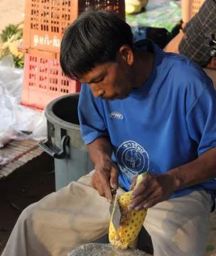 Carving a pineapple Stock Photos
