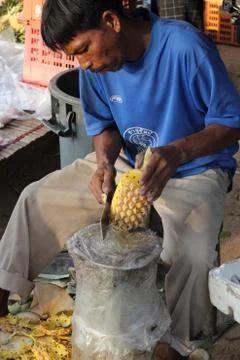 Carving a pineapple Stock Photos