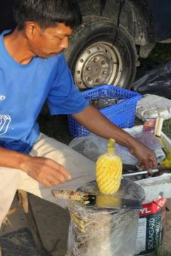 Carving a pineapple Stock Photos