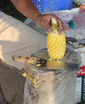 Carving a pineapple Stock Photos