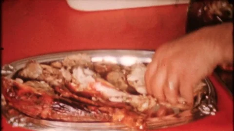 Carving up the turkey and placed on dinner platter 1950s vintage home movie 3927 Stock Footage