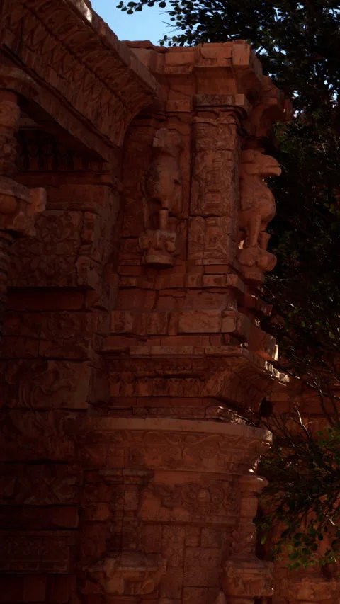 Carvings on ancient stone structure in a garden at night Stock Footage 342348597