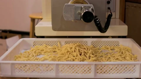 Casarecce falling, pasta machine, pasta maker, machine, basket, restaurant. 4K Stock Footage 162144475