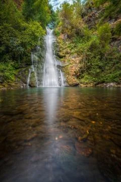 A cascade and its reflection in the river Stock Photos