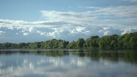 Cascade of clouds floats above the river Stock Footage 77588744