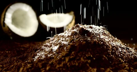 Cascade of coconut flakes falling on a mountain of cocoa 4k Stock Footage 87398746