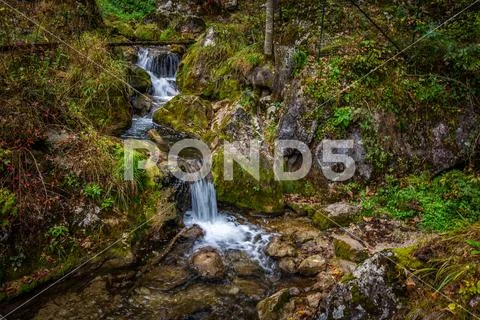 Cascade falls over mossy rocks at Myrafalle, near Muggendorf Stock Photos