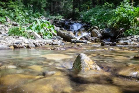 Cascade falls over mountain rocks Stock Photos