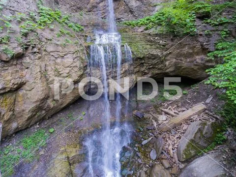 Cascade mountain waterfall. Aerial view. Stock Photos
