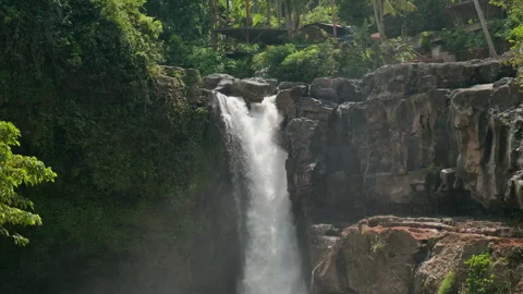 Cascade Over Dark Rock Cliff, Tegenungan Waterfall, Bali Видео 336637260