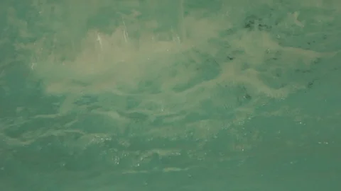 Cascade in a pool with greenish moving water splashing with a relaxing effect Stock Footage 88264298