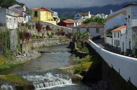Cascade river going through cozy city, beautiful view of Sao Miguel island Stock Photos
