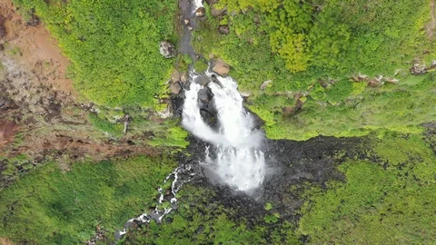 Cascade running down dark volcanic rock on Kauai, Hawaii Stock-Footage 96053619