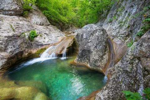 Cascade Water cascade in green spring forest. Copyright: xZoonar.com/Galyn... 스톡 사진