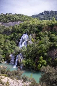 A cascade of water falling through the lush vegetation, Campillo waterfall, in Stock Photos