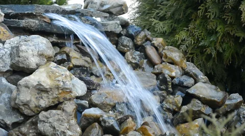 Cascade of Water Flowing Over Rocks Stock Footage 64826993