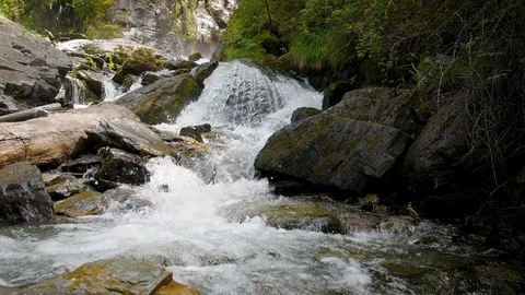Cascade waterfall slow motion. Streams of water among huge boulders. Clean Stock Footage 95524799