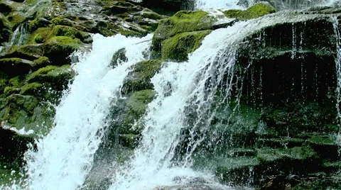 Cascade waterfall splash on stones in forest among mountains. Stock Footage 65486136