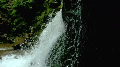 Cascade waterfall splash on stones in forest among mountains. Video stock 65491791