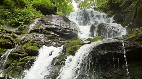 Cascade waterfall splash on stones in forest among mountains. Slow motion. Stock Footage 65530328