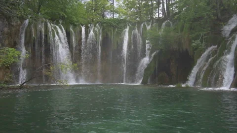 Cascades flowing into emerald pool at Plitvice Stock Footage 319782464