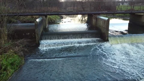 Cascading bubbling river weir water flowing drone footage 動画素材 166929454