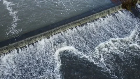 Cascading bubbling river weir water flowing drone footage 動画素材 166929481