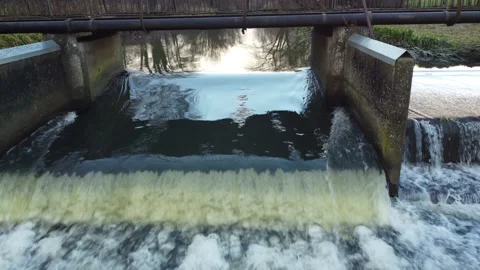Cascading bubbling river weir water flowing drone footage 動画素材 166929510