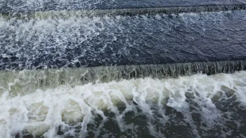 Cascading bubbling river weir water flowing drone footage 動画素材 166929523