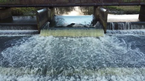 Cascading bubbling river weir water flowing drone footage 動画素材 166929578