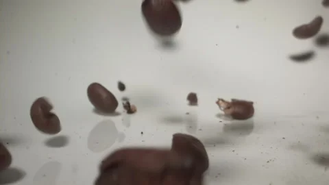 Cascading coffee beans slow motion on white background Stock Footage 144782048