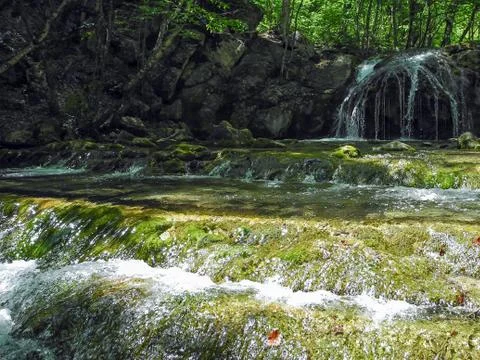 Cascading river with beautiful river thresholds and waterfall in the green sp 写真素材
