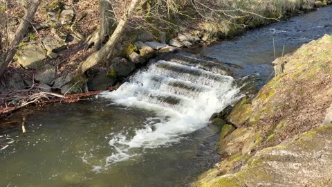 Cascading river water flowing over manmade steps Vídeos de archivo 334156745