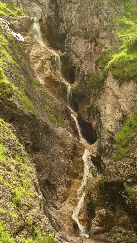 A cascading stepped waterfall in summer, vertical shot, Bavarian Alps, Jachenau Stock Footage 288142066