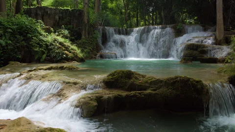 Cascading Turquoise Water Flows Over Limestone Rocks In Tropical Rainforest.. Video stock 338232416