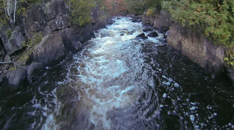 Cascading water between massive rocks Stock Footage 63866406