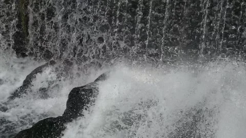 Cascading Water Creates Foamy Pool Scene, Industrial River Scene Showcases Video stock 323777311