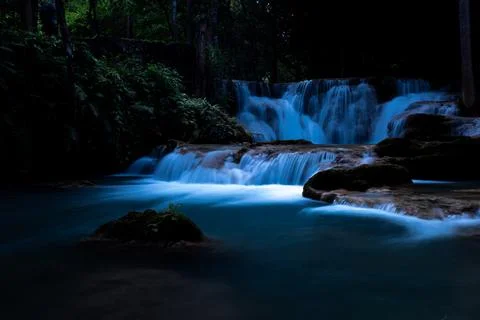Cascading Water Flowing Through Dark Tropical Jungle At Twilight In Huai Ma.. Fotos Stock
