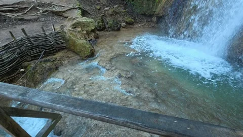 Cascading water flows over mossy rocks. Mount Ozren Vidéo 330551579