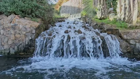 Cascading waterfall in 2 steps in a small town, with a strong flow of water Stock Footage 168487167