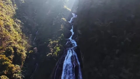 Cascading Waterfall Flowing Over Dark Rocks in Lush Forest Yunnan China Stock-Footage 346985994