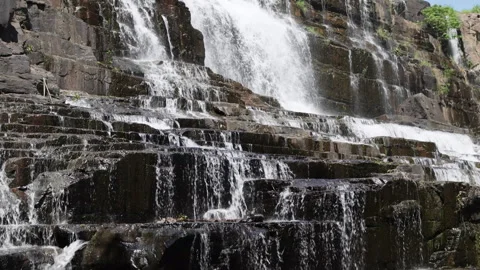 Cascading waterfall flowing over rocky steps. Stock Footage 276823474