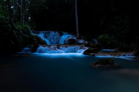 Cascading Waterfall Flowing Through Dark Forest At Night In Huai Mae Khamin.. 写真素材