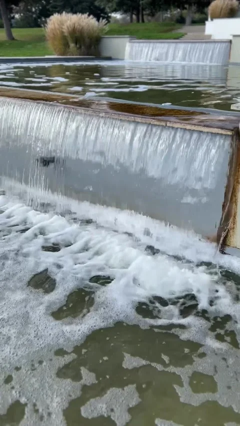Cascading waterfall in a modern garden. Streams of water pour down. Stock Footage 293454111